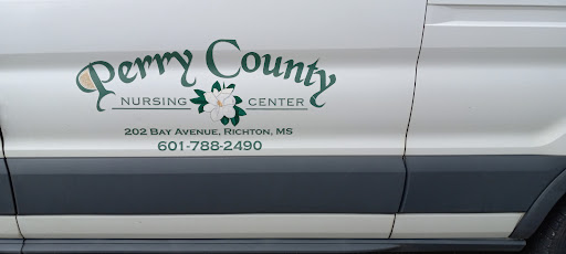 A side view of a vehicle displaying the logo and contact details of a nursing center in Perry County.
