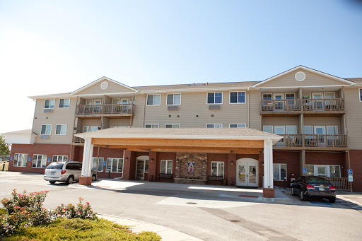 A view of a modern residential building featuring balconies and an inviting entrance.