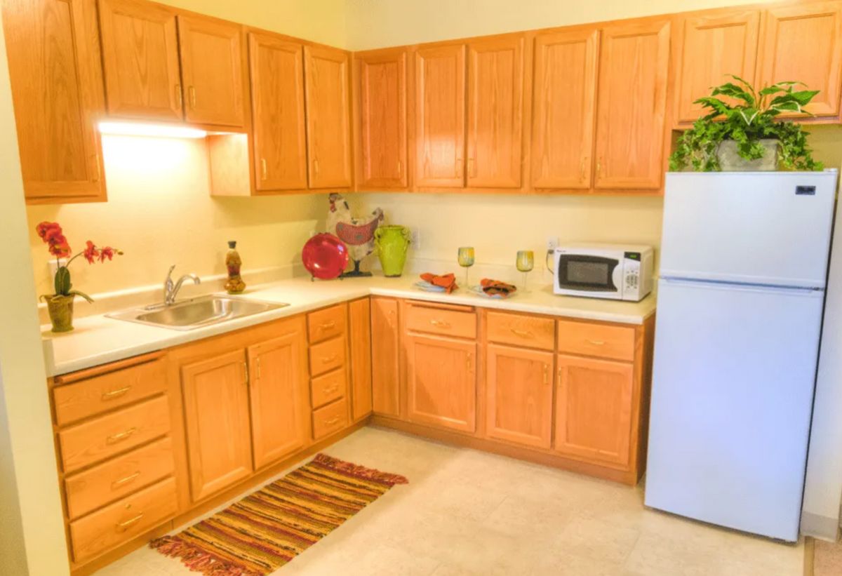 A cozy kitchen with wooden cabinets and modern appliances.