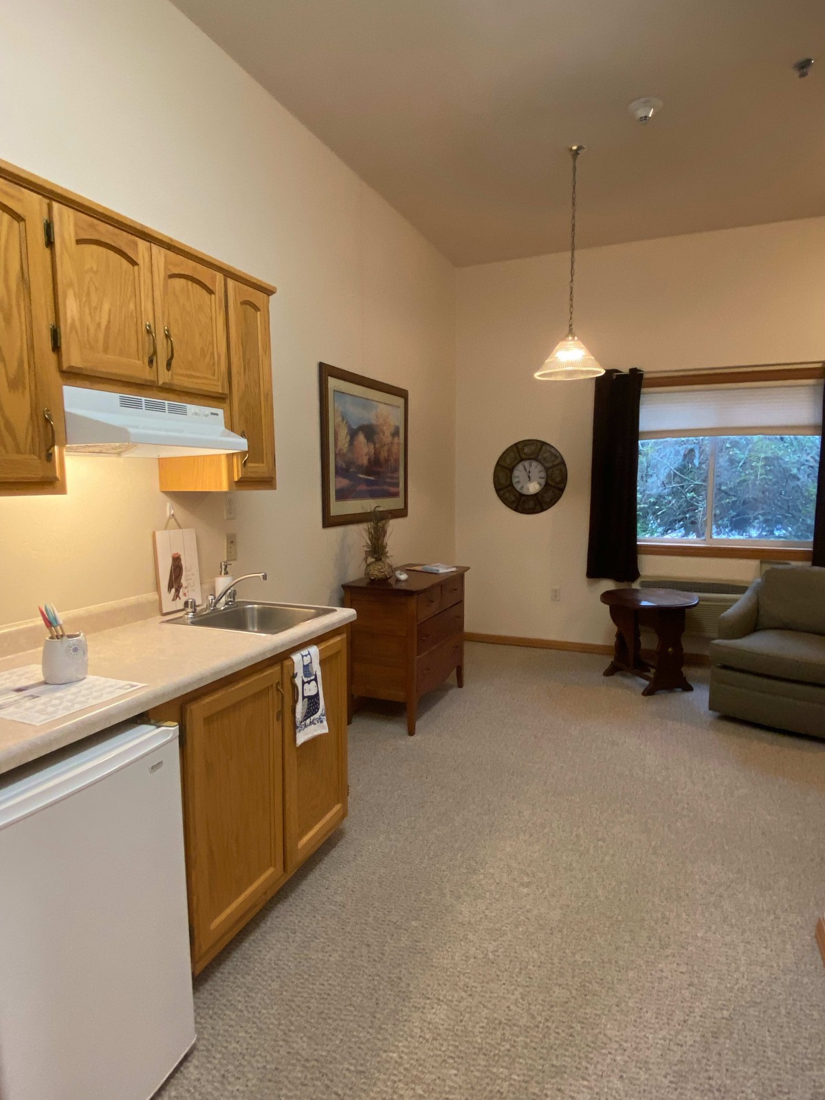 A cozy interior featuring a small kitchen and comfortable living area.