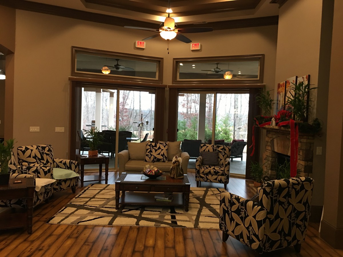 A cozy living room with comfortable seating and natural light from large glass doors.
