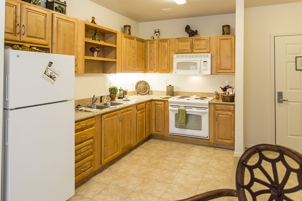 A cozy kitchen with wooden cabinets and modern appliances.