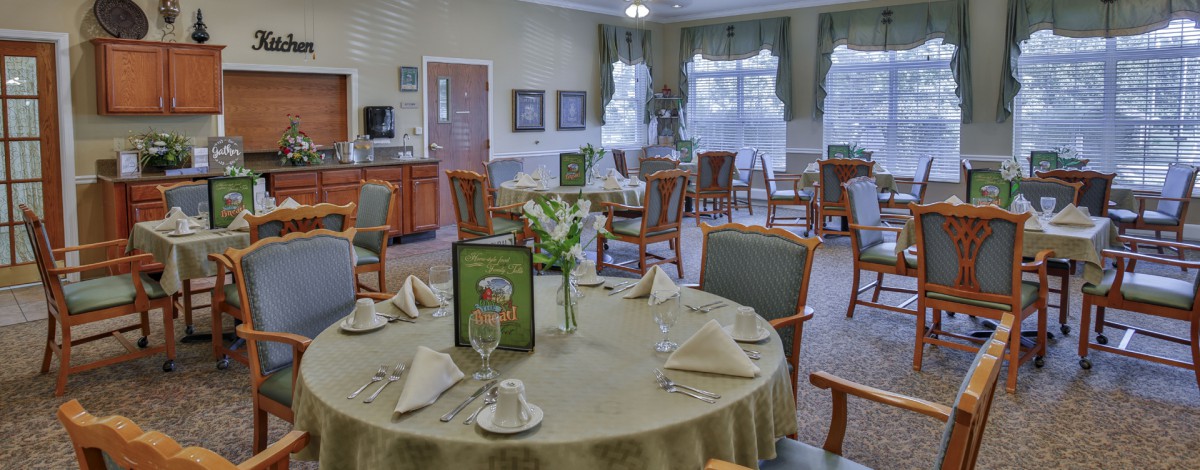 A well-set dining room with elegantly arranged tables and chairs.