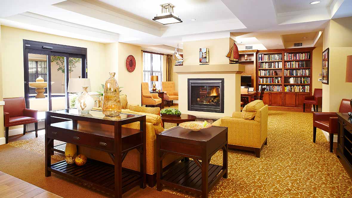 A cozy living room with a warm fireplace and comfortable seating.