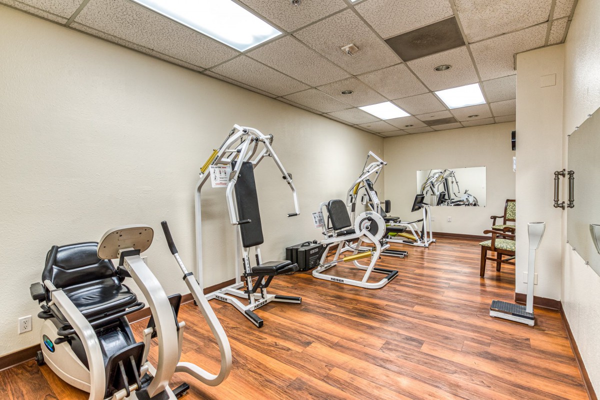 A small indoor gym with various fitness equipment and exercise machines.