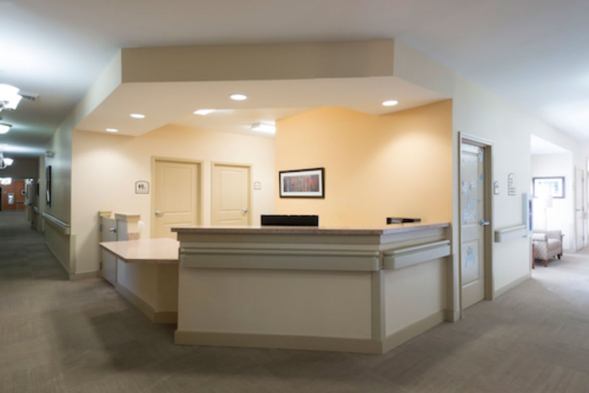 A modern reception desk in an office lobby.