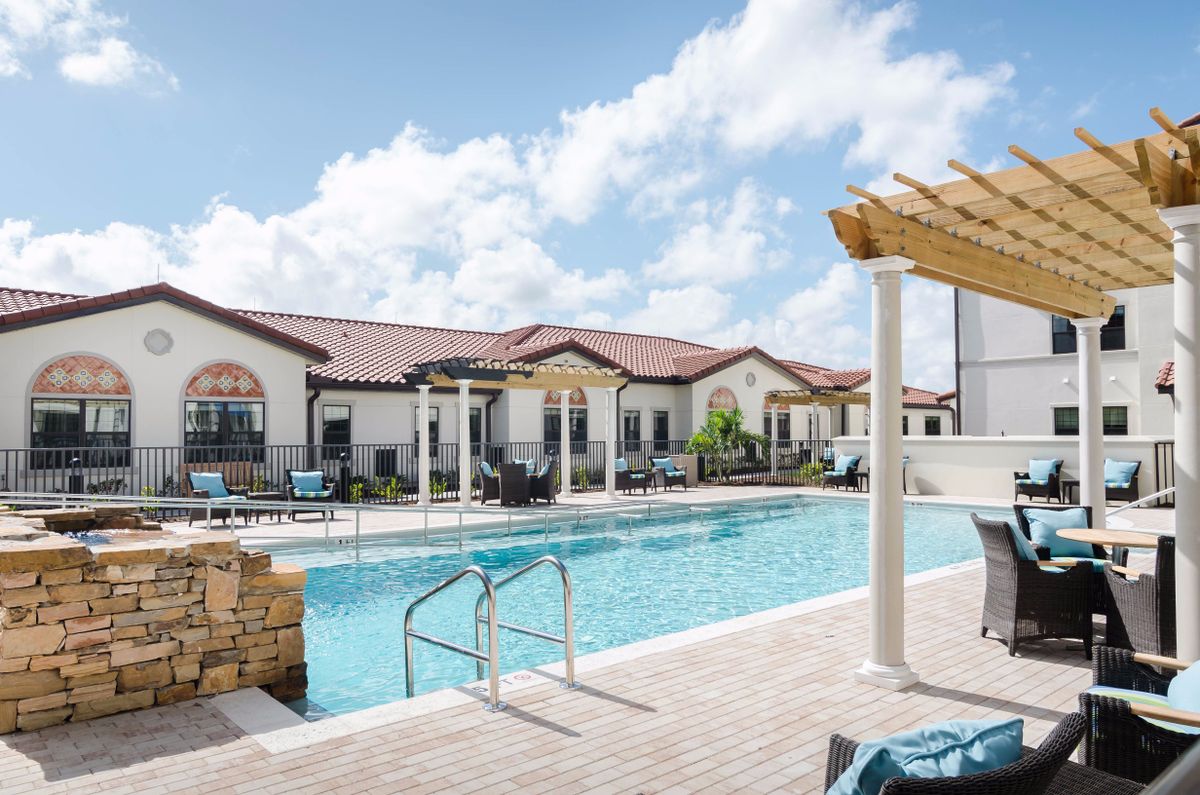 A luxurious outdoor pool area at a resort, perfect for a sunny day relaxation.