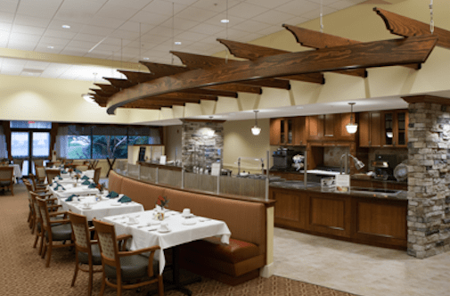 A cozy restaurant interior with wooden ceiling decor and a comfortable dining area.