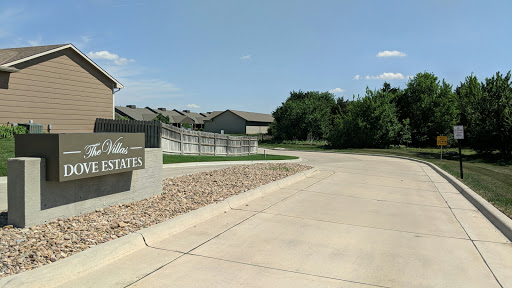 Entrance to a residential apartment complex on a sunny day.
