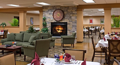 A cozy dining area featuring a stone fireplace and inviting seating.