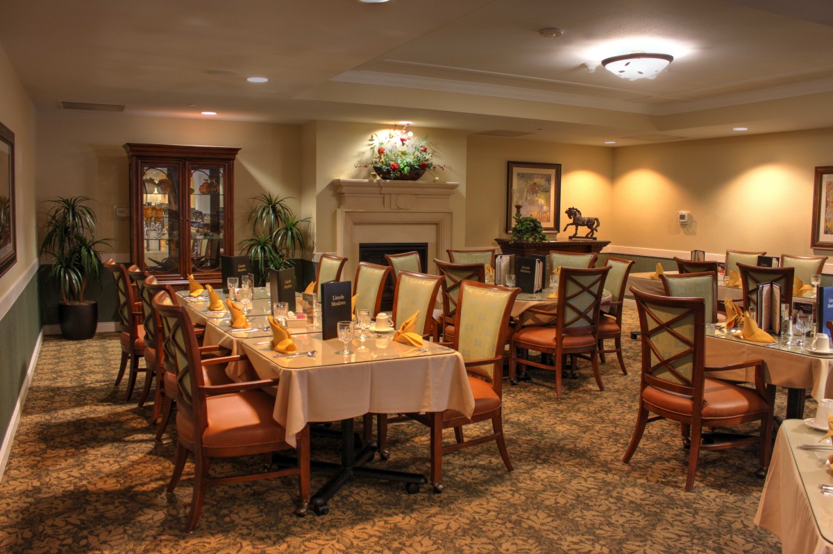 An elegant dining area with meticulously arranged tables and cozy lighting.