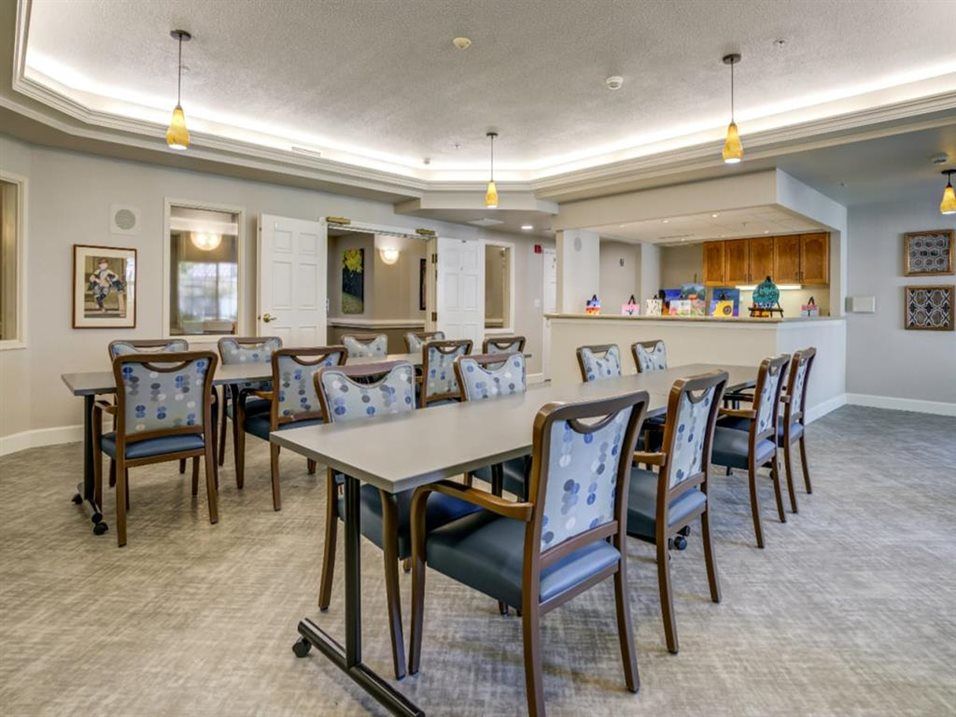 A modern dining area with neatly arranged tables and chairs.