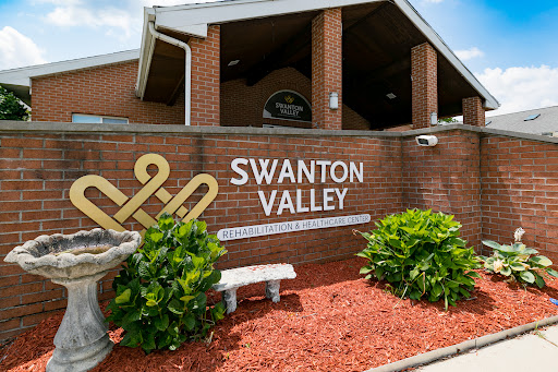 Entrance to Swanton Valley showcasing the community's name and surrounding landscaping.