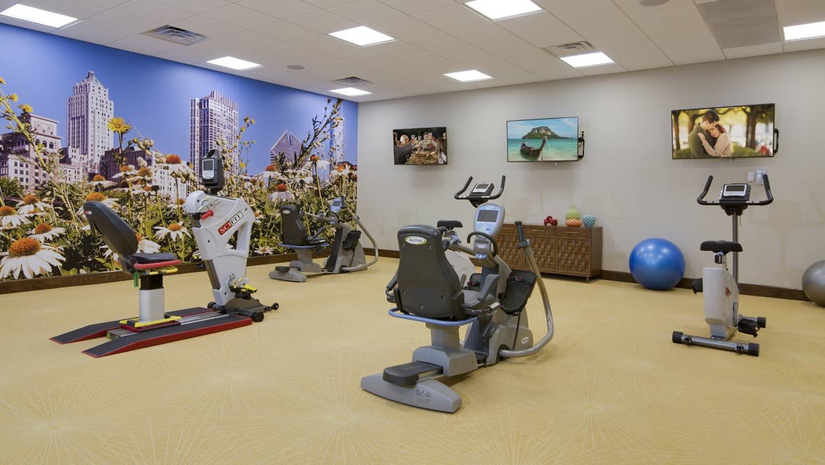 A well-equipped gym with stationary bikes, treadmills, and exercise machines.