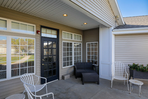 A cozy outdoor patio featuring modern furniture and a welcoming entrance.