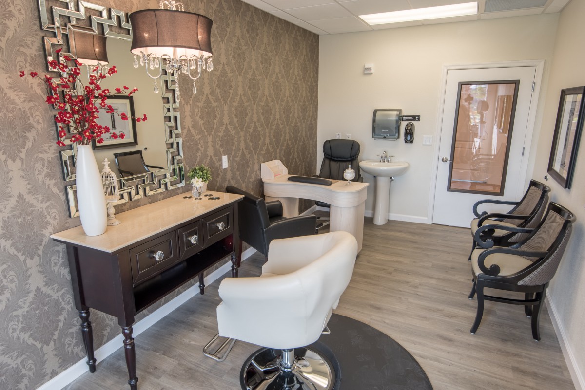 A stylish salon interior with modern furniture and decorative elements.