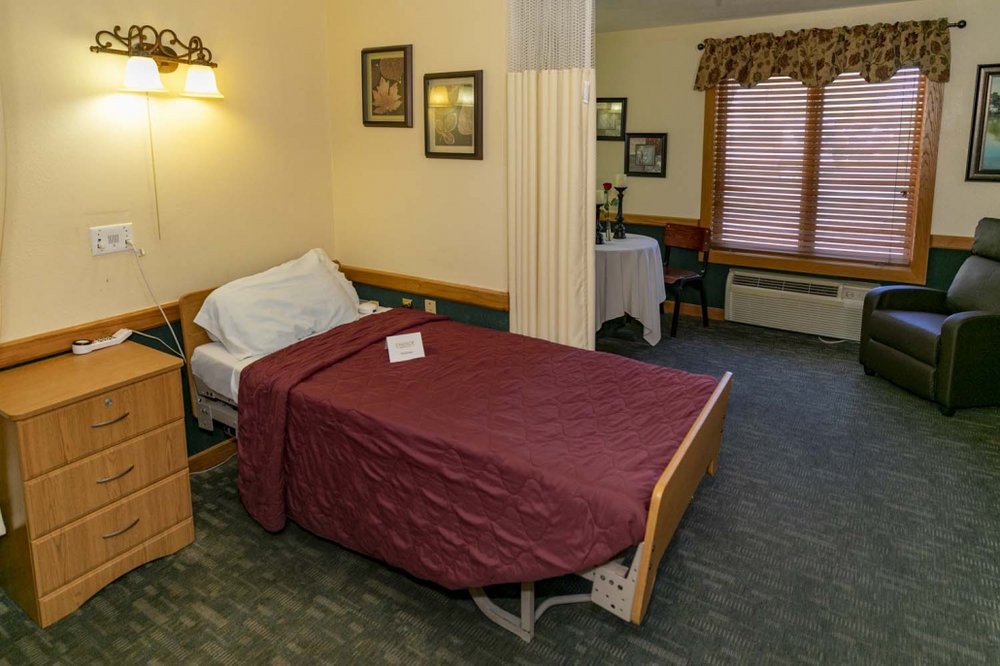 A hospital room with a single bed and cozy decor.