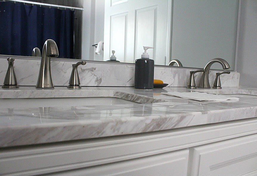 Modern bathroom with a marble countertop and stylish fixtures.