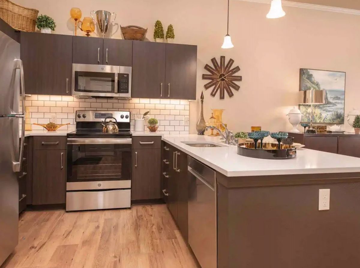 A modern kitchen with sleek cabinetry, stainless steel appliances, and stylish decor.
