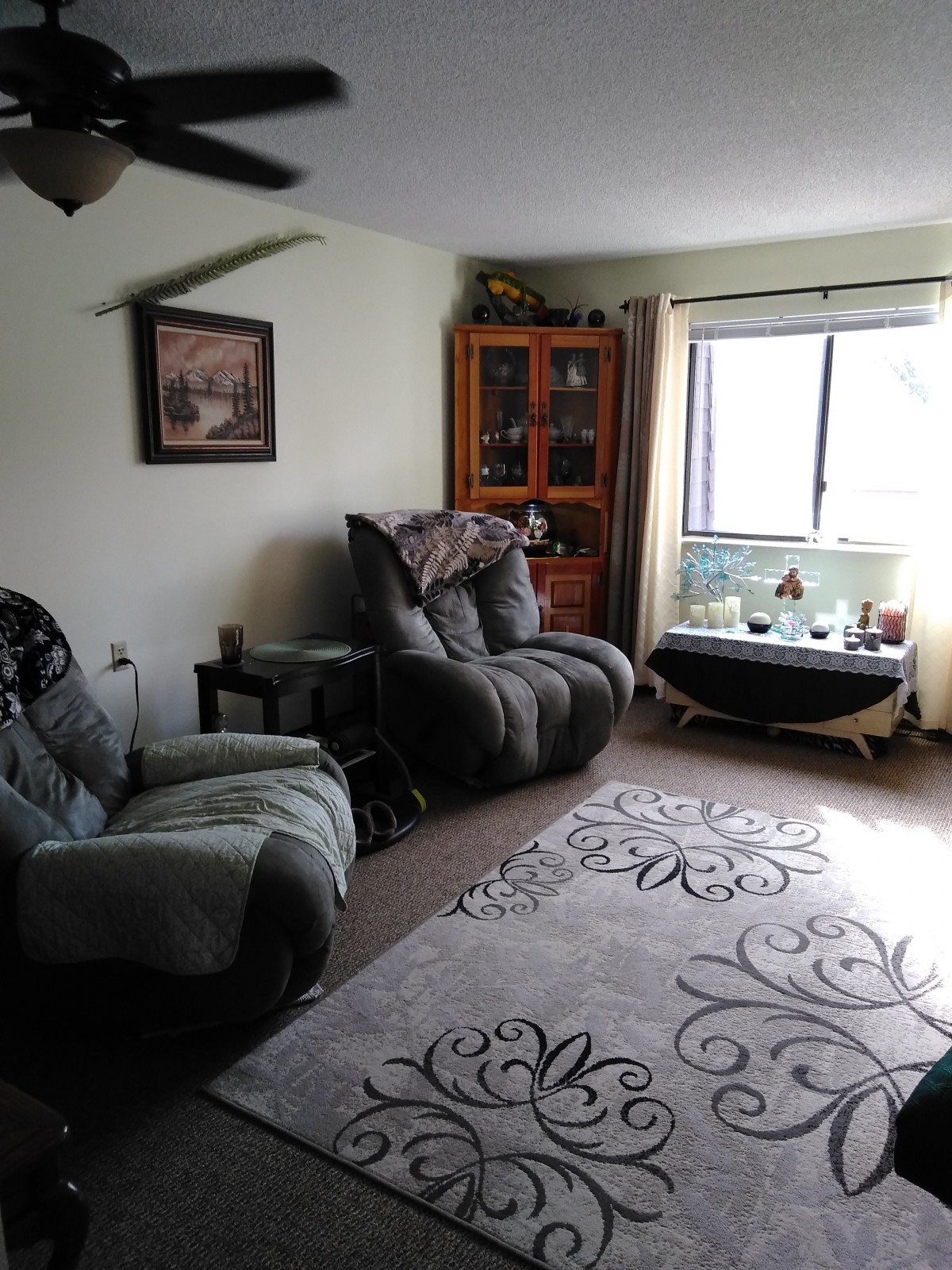 A cozy living room with comfortable seating and a window view.