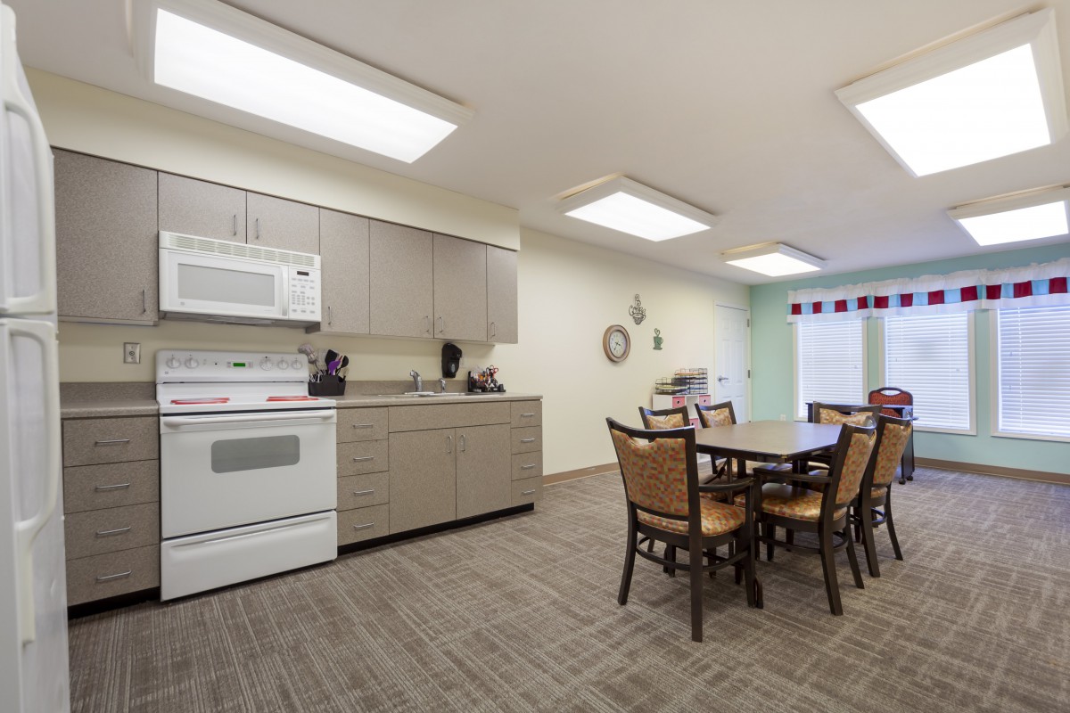 A modern kitchen and dining area with bright lighting and contemporary furnishings.