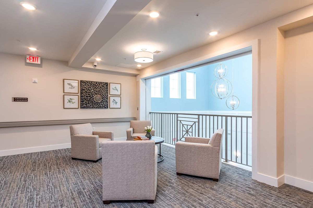 A modern lounge area with comfortable seating and contemporary artwork.