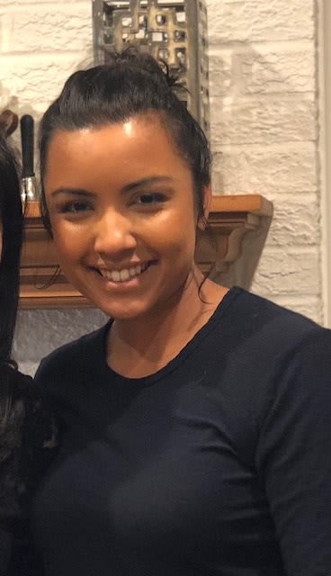 A woman smiling indoors.