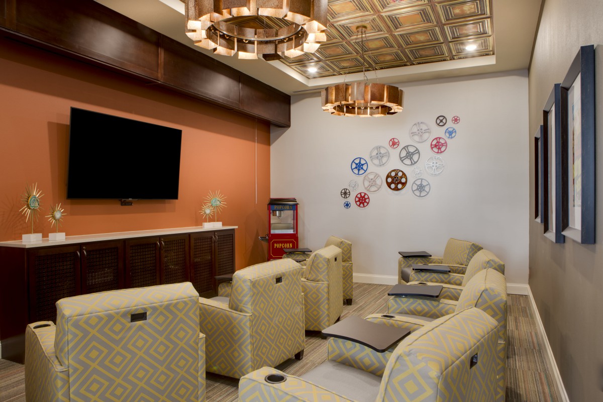A stylish home theater room with comfortable seating and modern decor.