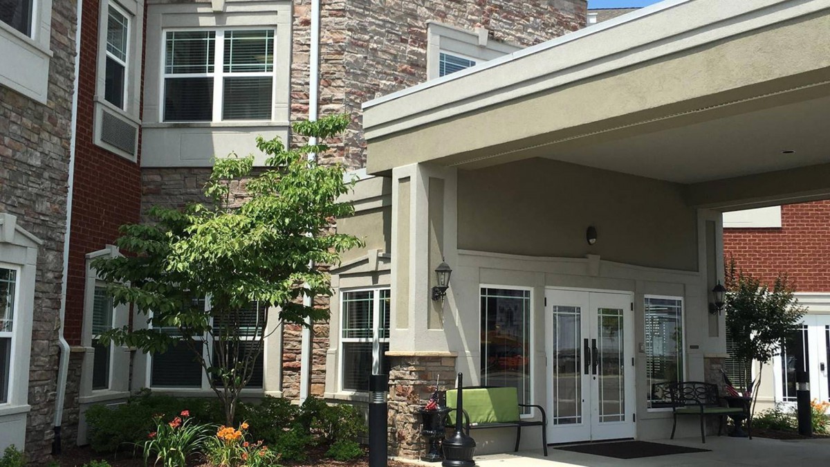 The exterior of a modern building with a welcoming entrance and landscaped surroundings.