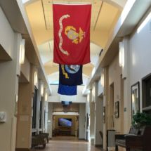 A hallway adorned with hanging flags and illuminated by overhead lighting.