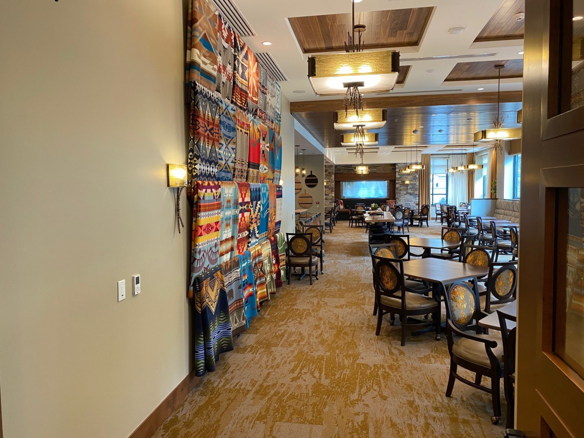 A cozy dining area with elegant lighting and a colorful decorative wall.