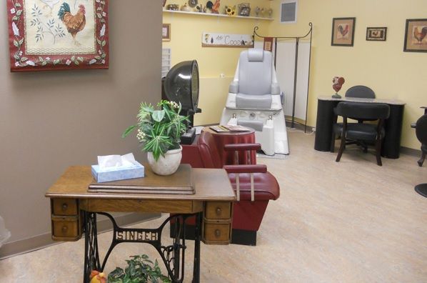 A cozy office waiting area with seating and decorative plants.