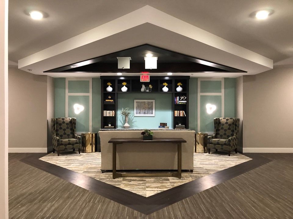 A modern reception area with stylish furniture and ambient lighting.