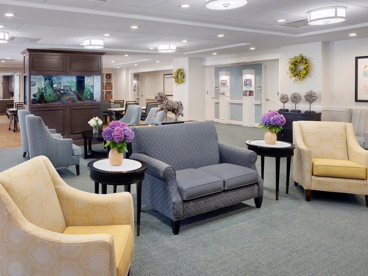 A modern lobby with comfortable seating and floral decor.