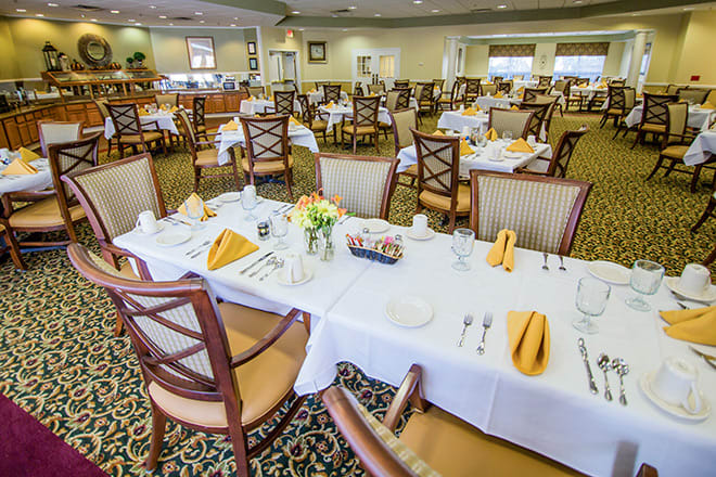 An elegant indoor dining room with neatly arranged tables and chairs.