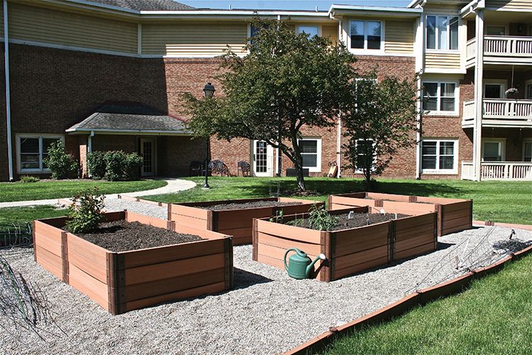 A community garden with raised beds in an urban setting.