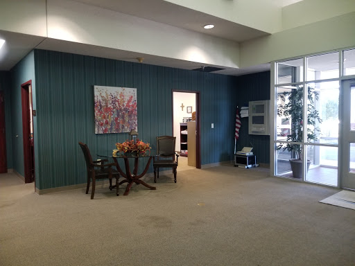 A cozy waiting area featuring comfortable chairs and an artistic touch.
