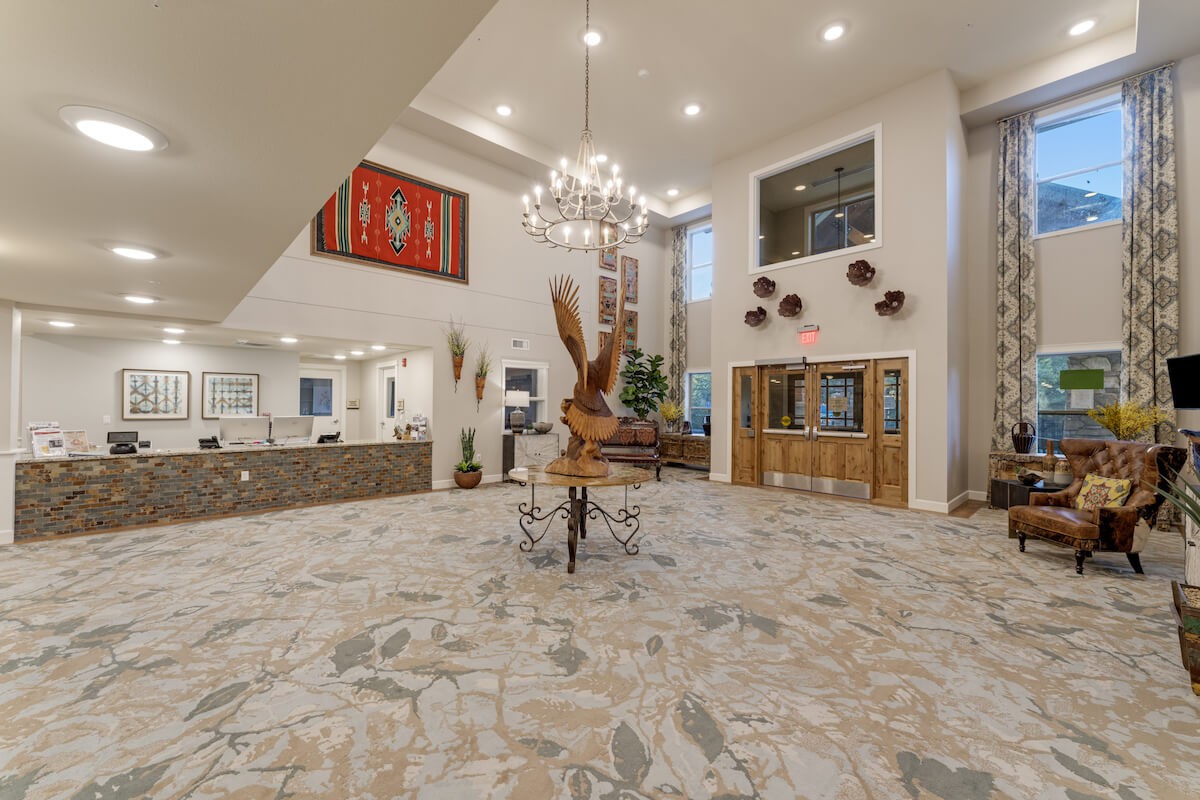 Spacious lobby area featuring modern decor with a chandelier and art pieces.
