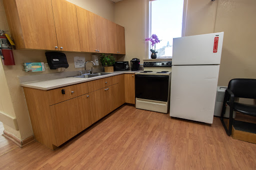 A well-equipped kitchen featuring wooden cabinets and essential appliances.