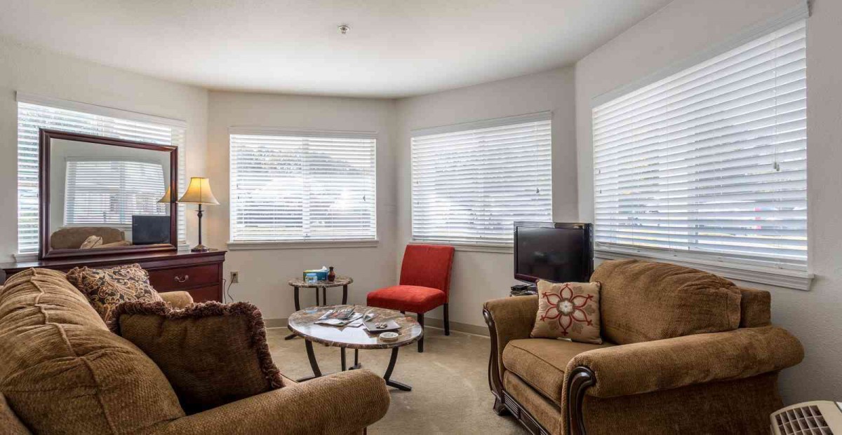 A cozy living room with comfortable seating and ample natural light.