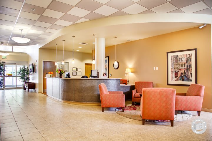 A modern lobby with comfortable seating and a reception desk.