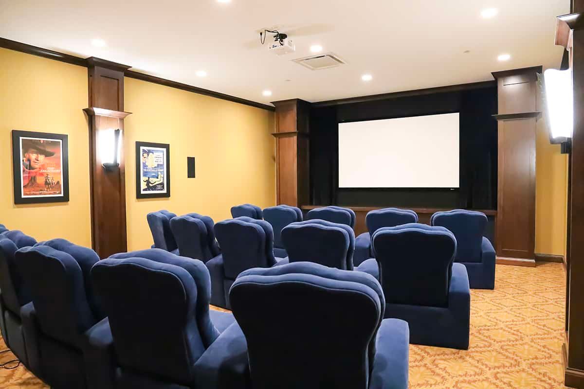 A cozy home theater room with comfortable seating and a large screen.