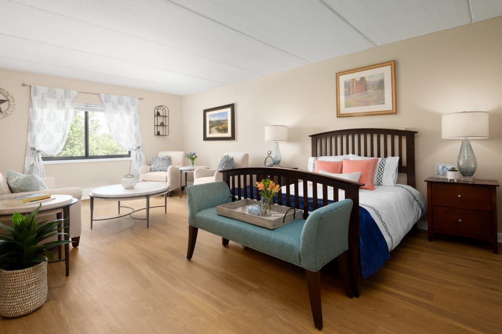 A spacious and well-lit bedroom with elegant furniture and decor.