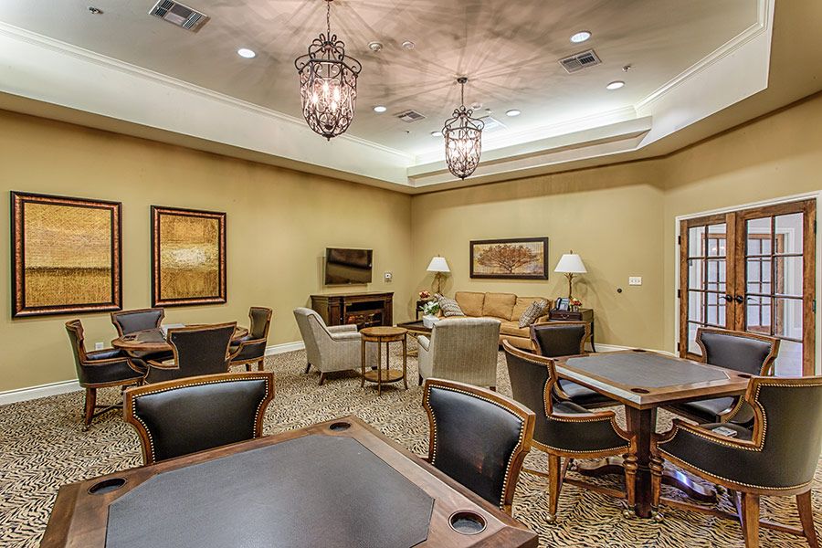 A comfortable lounge room with seating and tables.