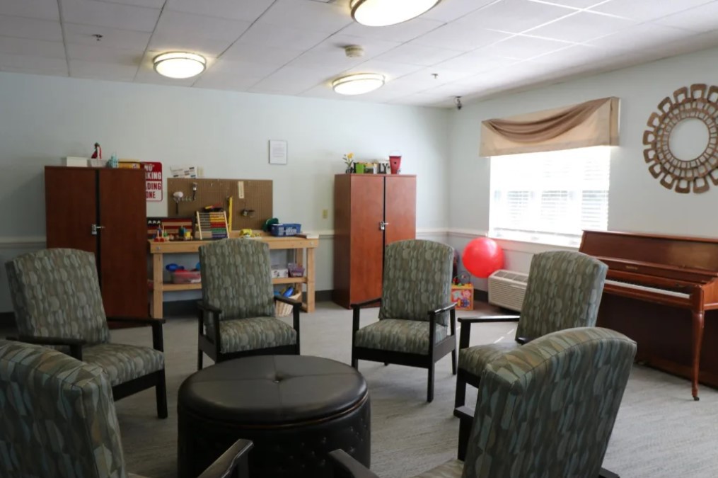 A therapy room with chairs arranged in a circle for group sessions.