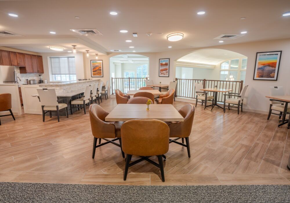 A modern lounge area with comfortable seating and wooden flooring.