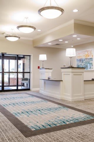 A modern hotel lobby with a reception desk and stylish lighting.