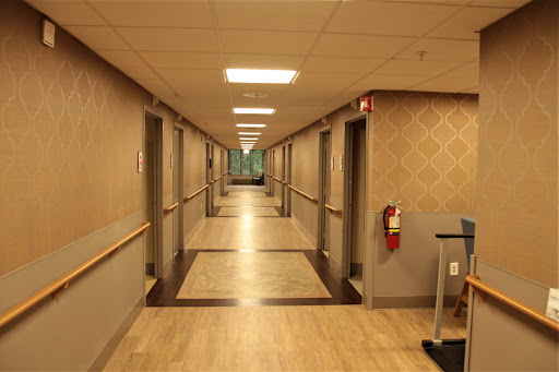 A well-lit hallway featuring doors on either side.
