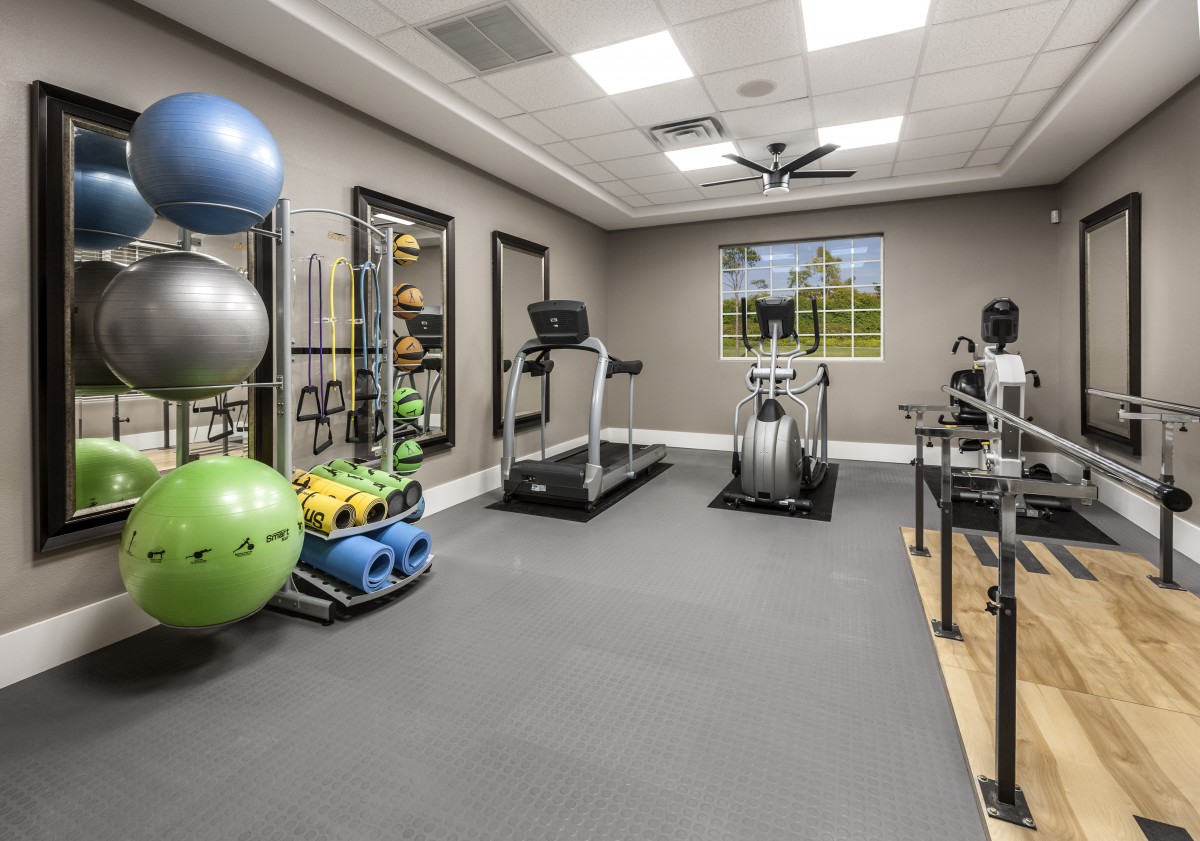 A well-equipped home gym with various exercise machines and fitness accessories.