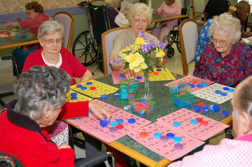 A group of elderly individuals enjoying a game of bingo at a community center.